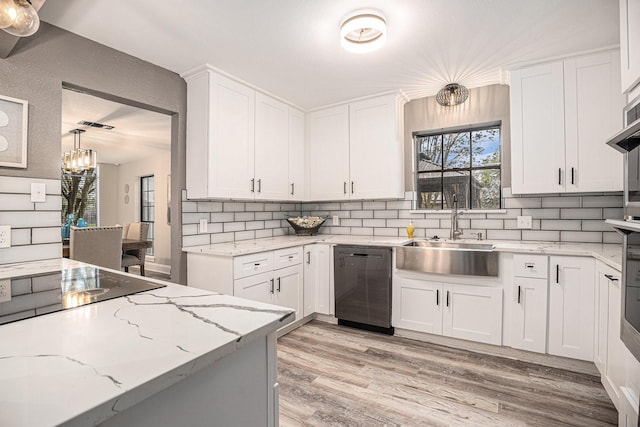 3611 18th St N, Texas City, TX 77590 - kitchen with dishwasher, light wood-style floors, decorative backsplash, and healthy amount of natural light