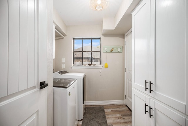 3611 18th St N, Texas City, TX 77590 - laundry room featuring washing machine and clothes dryer, light wood-style floors, and cabinet space