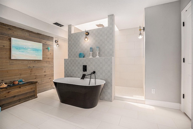 3611 18th St N, Texas City, TX 77590 - full bathroom with walk in shower, a soaking tub, tile patterned flooring, and wood walls