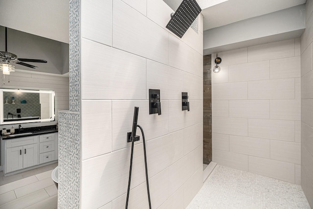 3611 18th St N, Texas City, TX 77590 - bathroom with ceiling fan, a tile shower, vanity, and tile patterned flooring