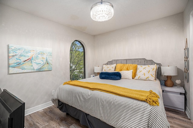 3611 18th St N, Texas City, TX 77590 - bedroom featuring wood finished floors and a chandelier