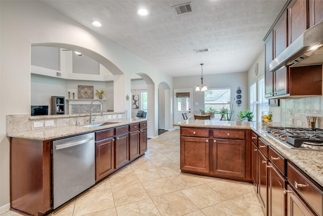 3602 Buchanan Hill Ln, Katy, TX 77494 - kitchen featuring appliances with stainless steel finishes, range hood, a peninsula, light stone countertops, and hanging light fixtures