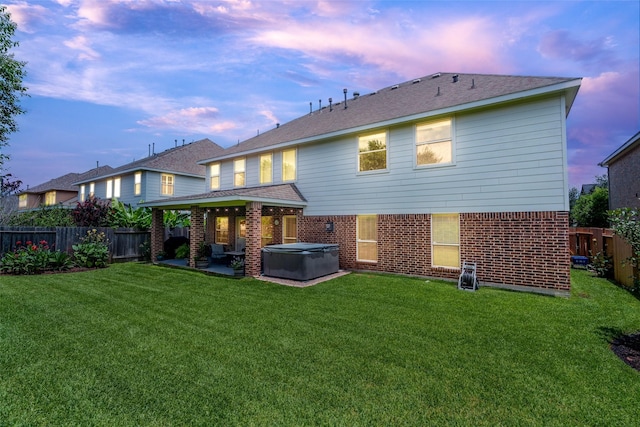 3602 Buchanan Hill Ln, Katy, TX 77494 - back of property with a hot tub, a fenced backyard, a patio, and brick siding