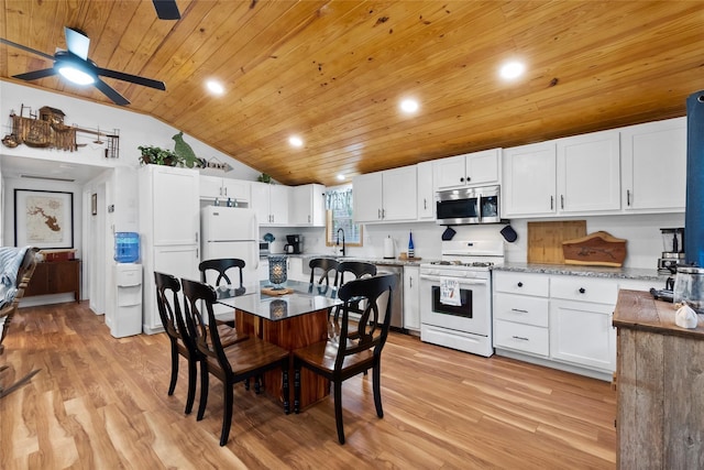 236 Fern, Livingston, TX 77351 - kitchen featuring stainless steel appliances, vaulted ceiling, wood ceiling, white cabinetry, and light wood finished floors