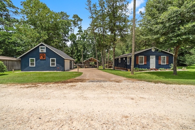 236 Fern, Livingston, TX 77351 - view of front of property featuring a front yard, concrete driveway, a carport, and view of wooded area