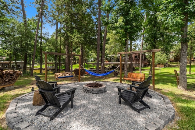 236 Fern, Livingston, TX 77351 - view of patio featuring a fire pit, a playground, and view of scattered trees