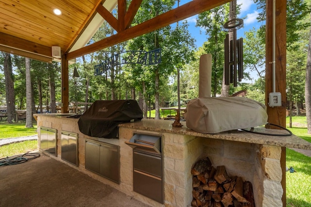236 Fern, Livingston, TX 77351 - view of patio featuring exterior kitchen and view of wooded area