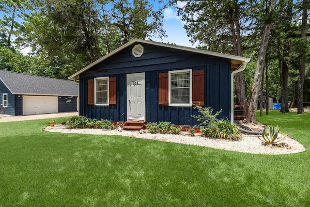 236 Fern, Livingston, TX 77351 - view of front of property with board and batten siding, a front yard, and a garage
