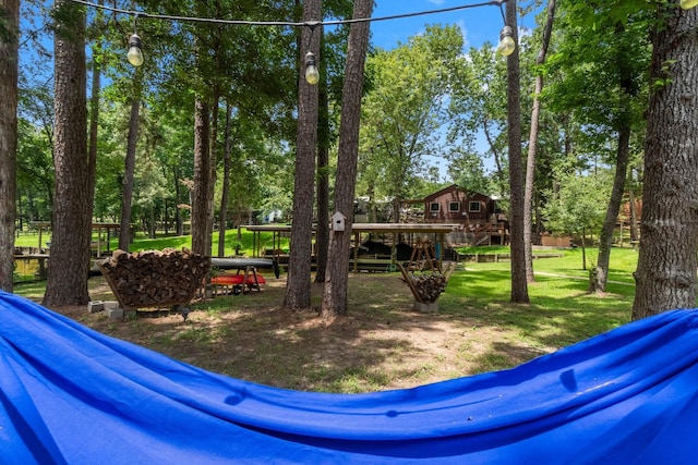 236 Fern, Livingston, TX 77351 - view of green lawn featuring a deck and view of scattered trees