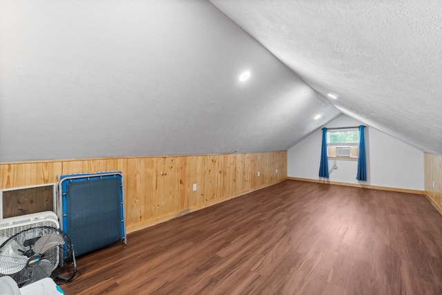 236 Fern, Livingston, TX 77351 - bonus room featuring wood finished floors, wood walls, a textured ceiling, lofted ceiling, and cooling unit