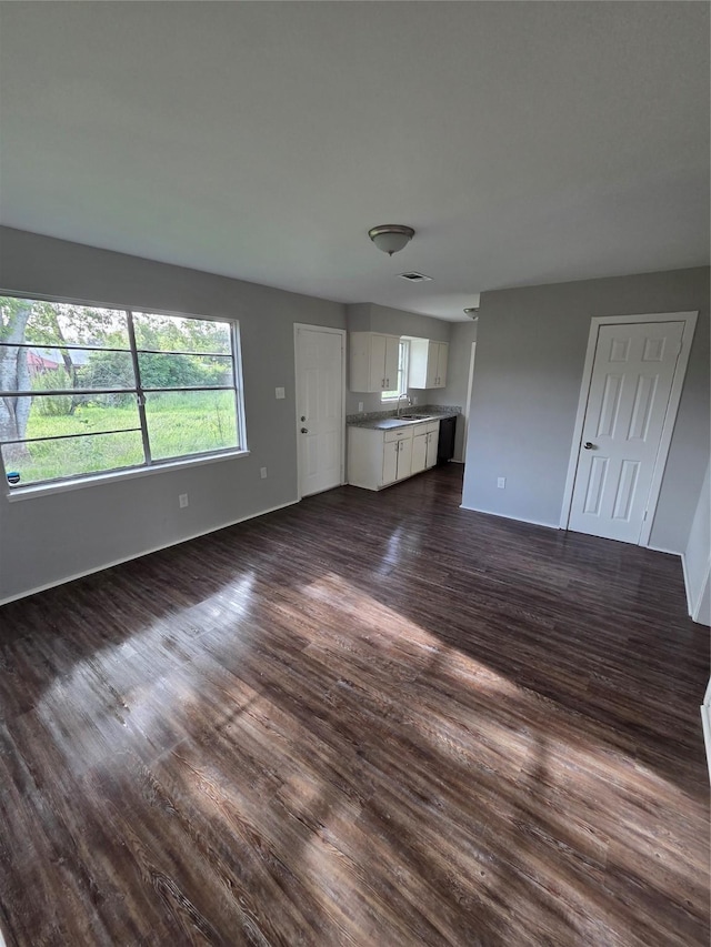 10606 Rubin St, Houston, TX 77047 - unfurnished living room featuring dark wood-style flooring and a sink