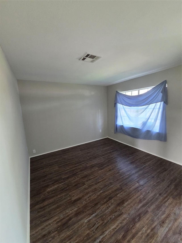 10606 Rubin St, Houston, TX 77047 - spare room featuring dark wood-type flooring and baseboards