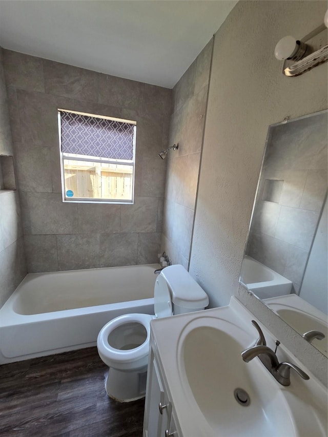 10606 Rubin St, Houston, TX 77047 - full bath featuring wood finished floors, vanity, a textured wall, and shower / washtub combination