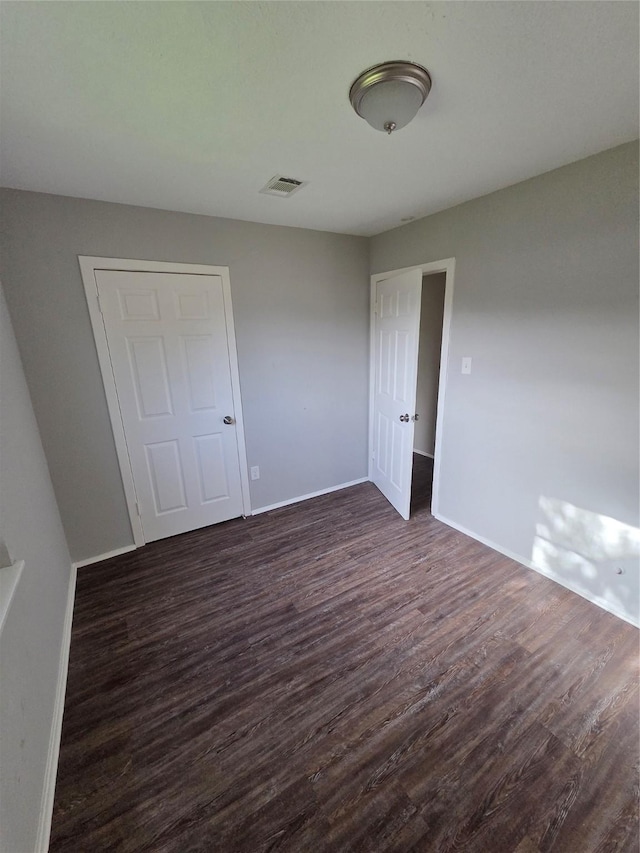 10606 Rubin St, Houston, TX 77047 - unfurnished bedroom with dark wood-style flooring and baseboards