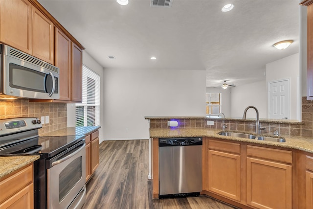 3510 Orchard Valley Ln, Spring, TX 77386 - kitchen with stainless steel appliances, backsplash, healthy amount of natural light, light stone countertops, and recessed lighting