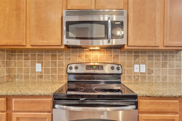 3510 Orchard Valley Ln, Spring, TX 77386 - kitchen with appliances with stainless steel finishes, tasteful backsplash, light brown cabinets, and light stone counters