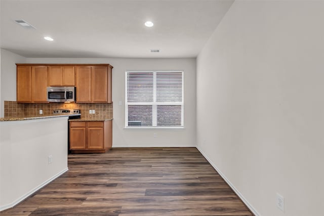 3510 Orchard Valley Ln, Spring, TX 77386 - kitchen with appliances with stainless steel finishes, tasteful backsplash, dark wood-style floors, recessed lighting, and light stone countertops