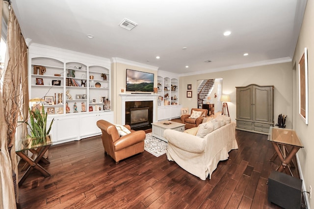 6310 Hermann Lake Dr, Houston, TX 77021 - living room with ornamental molding, dark wood-style floors, a glass covered fireplace, stairway, and recessed lighting