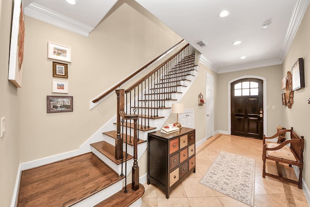 6310 Hermann Lake Dr, Houston, TX 77021 - entryway featuring ornamental molding, light tile patterned floors, recessed lighting, stairway, and arched walkways