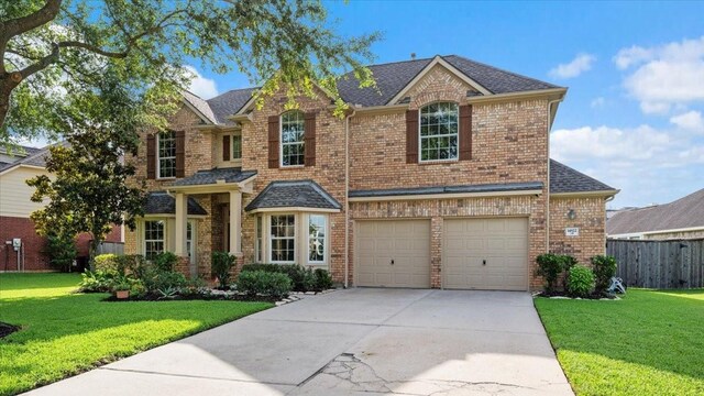 14822 Meridian Park Ln, Humble, TX 77396 - view of front of property featuring brick siding, concrete driveway, a garage, and roof with shingles