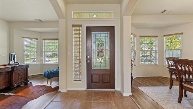 14822 Meridian Park Ln, Humble, TX 77396 - foyer featuring arched walkways, plenty of natural light, and wood finished floors