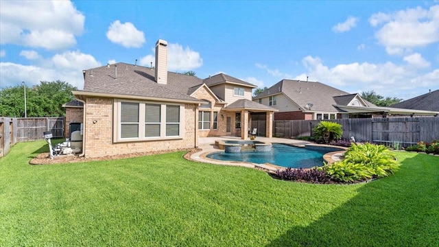 14822 Meridian Park Ln, Humble, TX 77396 - rear view of property featuring brick siding, a fenced backyard, a chimney, and a pool with connected hot tub
