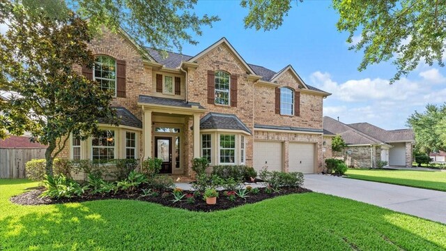 14822 Meridian Park Ln, Humble, TX 77396 - traditional home featuring brick siding, concrete driveway, an attached garage, and a shingled roof