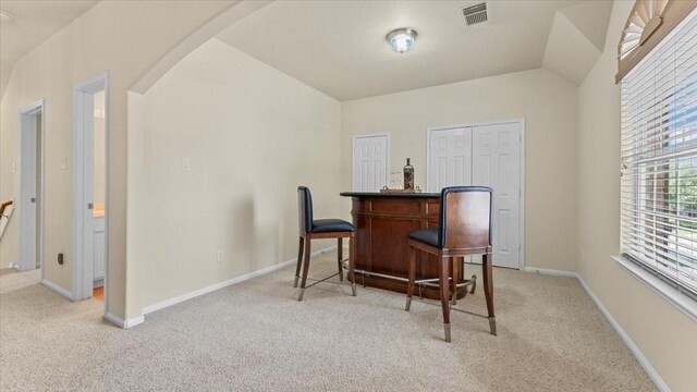 14822 Meridian Park Ln, Humble, TX 77396 - home office with arched walkways, light colored carpet, and a bar