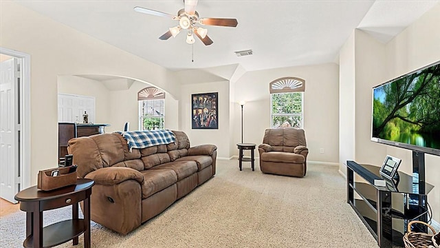 14822 Meridian Park Ln, Humble, TX 77396 - carpeted living room with arched walkways, ceiling fan, and plenty of natural light