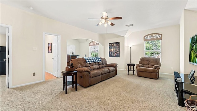 14822 Meridian Park Ln, Humble, TX 77396 - carpeted living room featuring arched walkways, ceiling fan, and plenty of natural light