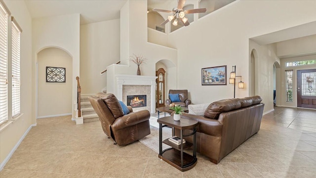 14822 Meridian Park Ln, Humble, TX 77396 - living area with arched walkways, light tile patterned floors, a towering ceiling, and a ceiling fan