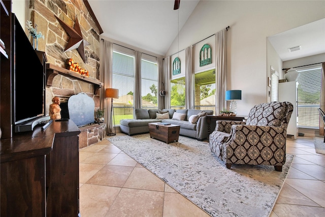 17003 Buffalo Peak Ct, Humble, TX 77346 - living area featuring light tile patterned flooring, lofted ceiling, plenty of natural light, and a stone fireplace