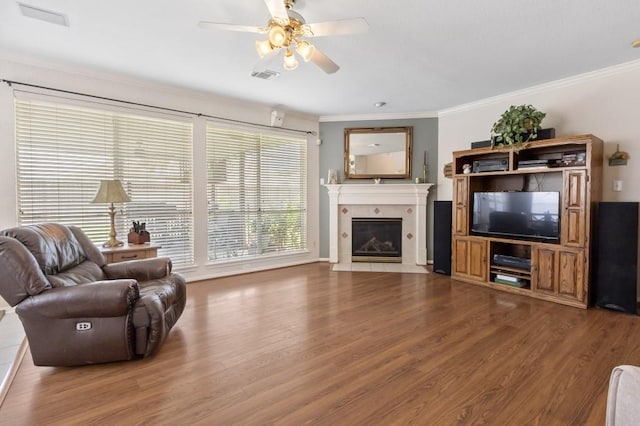10415 Claybrook Dr, Houston, TX 77089 - living room featuring wood finished floors, a ceiling fan, ornamental molding, and a tile fireplace