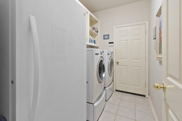 10415 Claybrook Dr, Houston, TX 77089 - laundry room with washer and clothes dryer and light tile patterned flooring