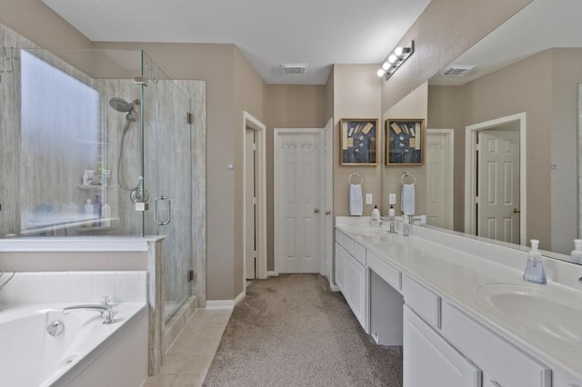 10415 Claybrook Dr, Houston, TX 77089 - bathroom featuring a stall shower, double vanity, a garden tub, and tile patterned flooring