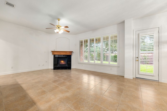 21510 Briar Landing Ln, Katy, TX 77450 - unfurnished living room featuring ceiling fan, light tile patterned floors, and a tile fireplace