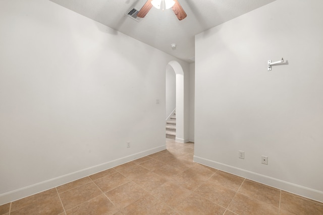 21510 Briar Landing Ln, Katy, TX 77450 - unfurnished room with arched walkways, a ceiling fan, stairway, and light tile patterned floors