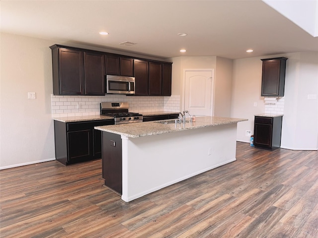 3022 Darlington Ct, Katy, TX 77494 - kitchen featuring stainless steel appliances, dark wood-type flooring, decorative backsplash, light stone counters, and recessed lighting