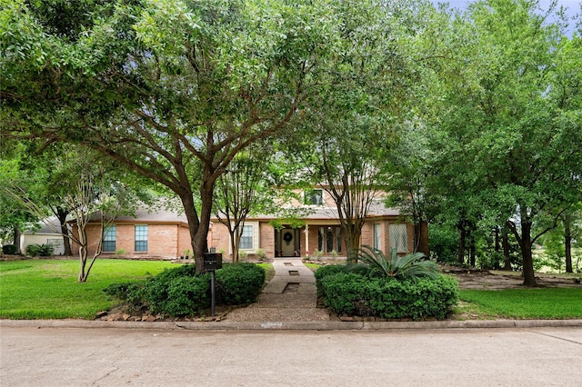 8519 Rebawood Dr, Humble, TX 77346 - view of front of property with brick siding and a front yard