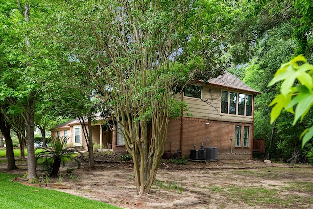 8519 Rebawood Dr, Humble, TX 77346 - view of side of property with brick siding and a central AC unit