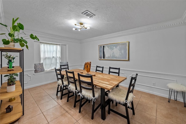 8519 Rebawood Dr, Humble, TX 77346 - dining room with crown molding, light tile patterned floors, and a textured ceiling
