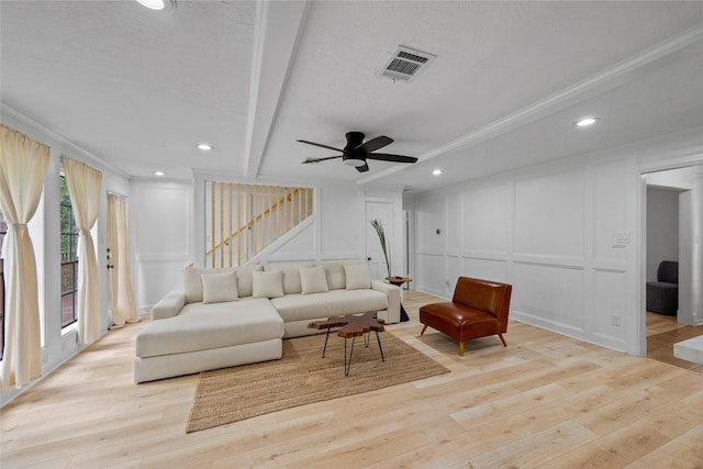 8519 Rebawood Dr, Humble, TX 77346 - living area with a decorative wall, stairway, light wood finished floors, ornamental molding, and beam ceiling