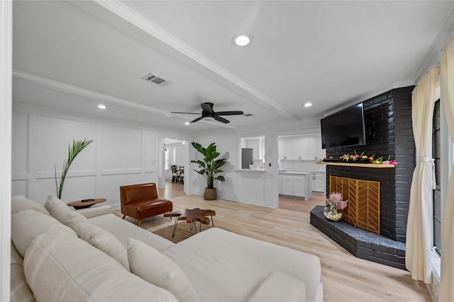 8519 Rebawood Dr, Humble, TX 77346 - living area with a fireplace, a decorative wall, recessed lighting, a ceiling fan, and ornamental molding