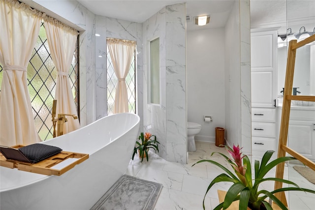 8519 Rebawood Dr, Humble, TX 77346 - full bathroom featuring plenty of natural light, a freestanding bath, marble finish flooring, and vanity