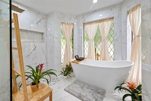 8519 Rebawood Dr, Humble, TX 77346 - bathroom with marble tiled flooring, a freestanding tub, and recessed lighting