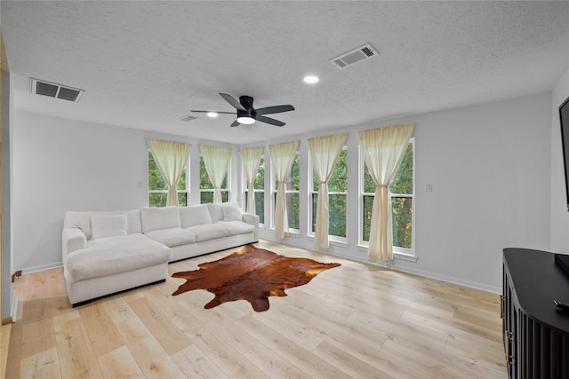 8519 Rebawood Dr, Humble, TX 77346 - living area featuring a textured ceiling, healthy amount of natural light, a ceiling fan, wood finished floors, and recessed lighting