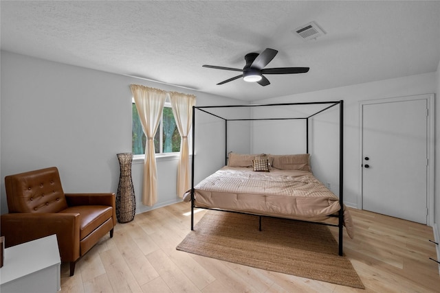 8519 Rebawood Dr, Humble, TX 77346 - bedroom with light wood-type flooring, ceiling fan, and a textured ceiling