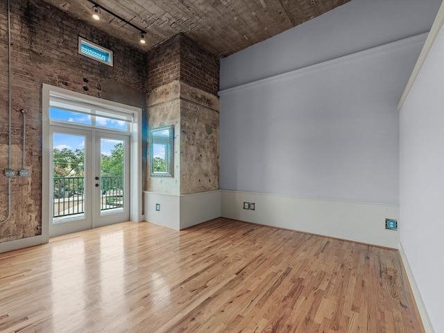 2700 Albany St Unit 3A, Houston, TX 77006 - spare room featuring track lighting, wood finished floors, french doors, and a high ceiling