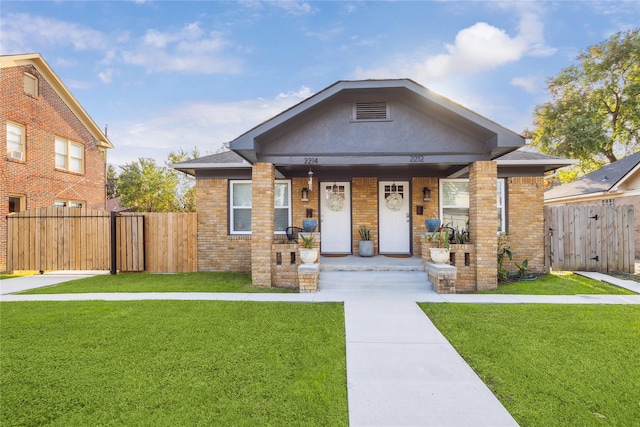 2212 Alabama St, Houston, TX 77004 - view of front of house with covered porch, a gate, and brick siding