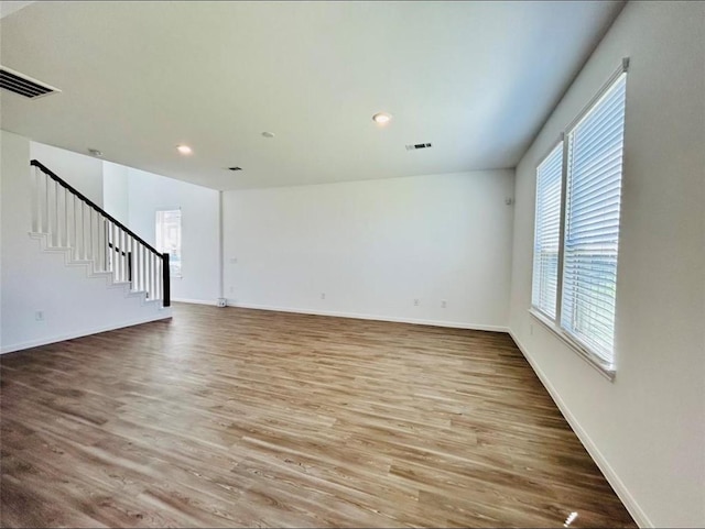1009 Laguna Cove Dr, Katy, TX 77493 - unfurnished living room featuring wood finished floors, stairs, and recessed lighting